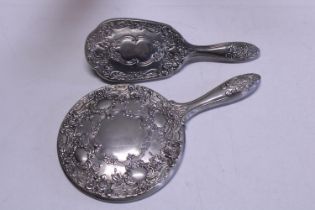 A silver plated mirror and brush set