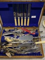 A selection of assorted flatware in a wooden cutlery box