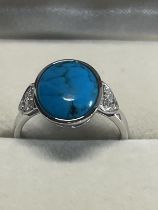 A hallmarked silver and turquoise ring