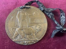 A WW1 death plaque awarded to George Mortimer (two small holes in the top)