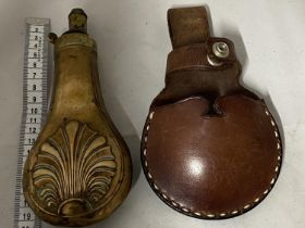 A antique copper and brass black powder flask and leather pouch