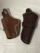 Two vintage leather pistol holsters