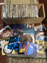 A job lot of mixed genre 7" singles, shipping unavailable