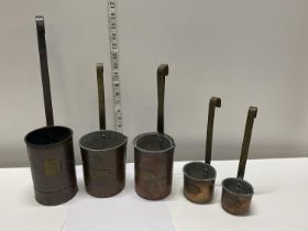 A set of six antique copper measuring jugs
