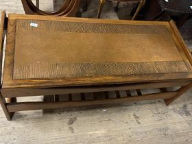 A vintage mid century coffee table with an unusual copper insert to the top. 117cm x 50cm. No