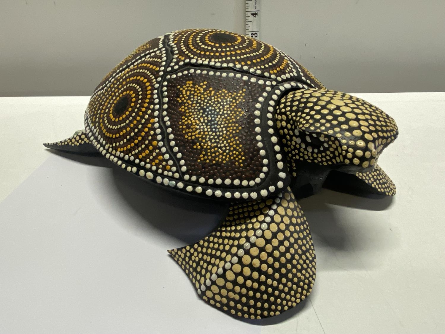An unusual hand carved wooden turtle with applied decoration