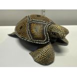 An unusual hand carved wooden turtle with applied decoration