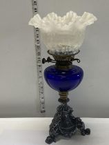 A nice quality Victorian oil lamp with a blue glass reservoir and milk glass shade. 43cm tall.