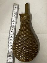 A antique brass black powder flask