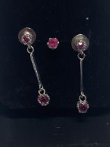 A commissioned pair of 9ct white gold & ruby earrings with additional stud.