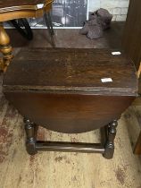 A small dark oak drop leaf table.47cm x 53cm x 45cm. No shipping.