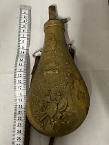 A reproduction U. S. Model 1855 Peace & Friendship, brass black powder flask