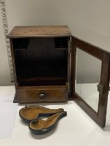 An antique oak smokers cabinet with internal pipe racks and glazed door with key. 30cm x 25 cm