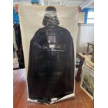 A large life size Darth Vader Star Wars poster