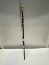 An unusual turned wooden walking cane with brass fittings. shipping unavailable