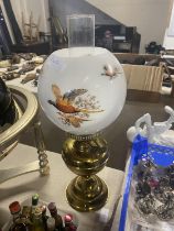A vintage brass and glass oil lamp with pheasant decoration to the glass shade. shipping unavailable