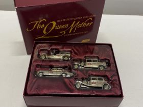 A limited edition boxed Lledo The Queen Mother Commemorative set of models in gold tone.