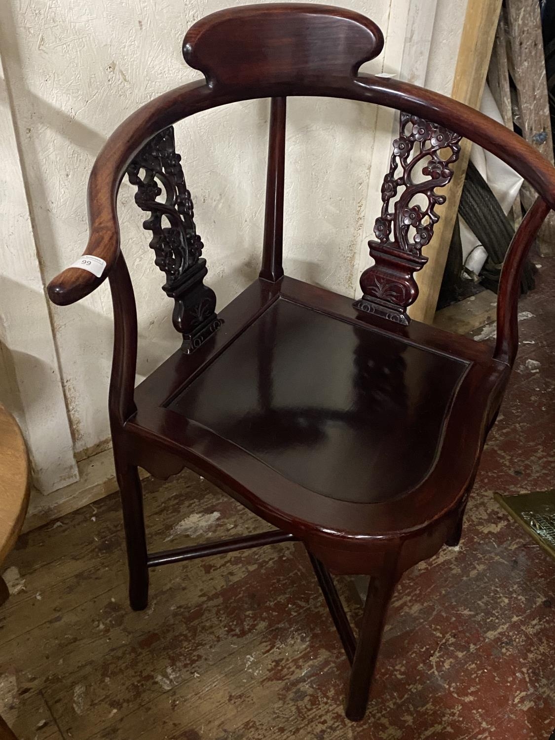 A good quality mahogany corner chair with hand carved decoration. No shipping