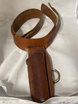 A vintage leather pistol and cartridge belt