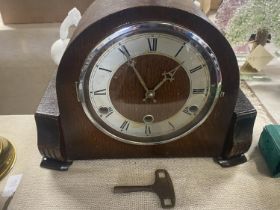 A 1930's wooden cased mantle clock with key & pendulum.