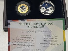 A pair of cased silver proof coins celebrating the handover to Rio for the Olympic games