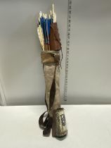 A selection of hand made Native American Indian style arrows two arm protectors together in a hand