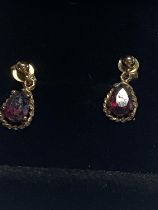 A pair of 9ct gold & red garnet drop earrings.