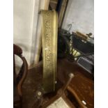 A vintage brass fire fender with pierce work decoration. No shipping