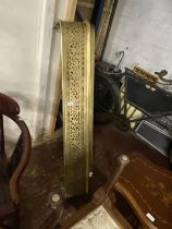 A vintage brass fire fender with pierce work decoration. No shipping