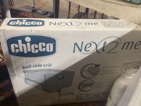 A boxed Chicco bedside crib. shipping unavailable