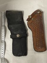 Two vintage leather pistol holsters