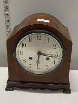 A wooden cased mantle clock with key & pendulum