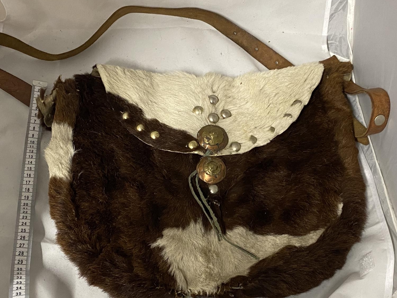 A vintage native Indian style hand sewn hunting shoulder bag made from animal hide