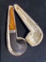 A vintage cased smokers pipe with silver mount