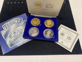 A Sterling silver plated & gold plated four coin set & a 1983 UK UNC coin set.