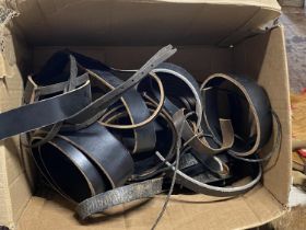 A box full of assorted leather straps etc