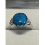 A hallmarked 18ct gold and turquoise ring. 3.93 grams total weight. Size M