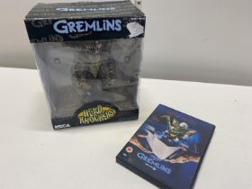 A boxed Gremlins Neca figure and a DVD