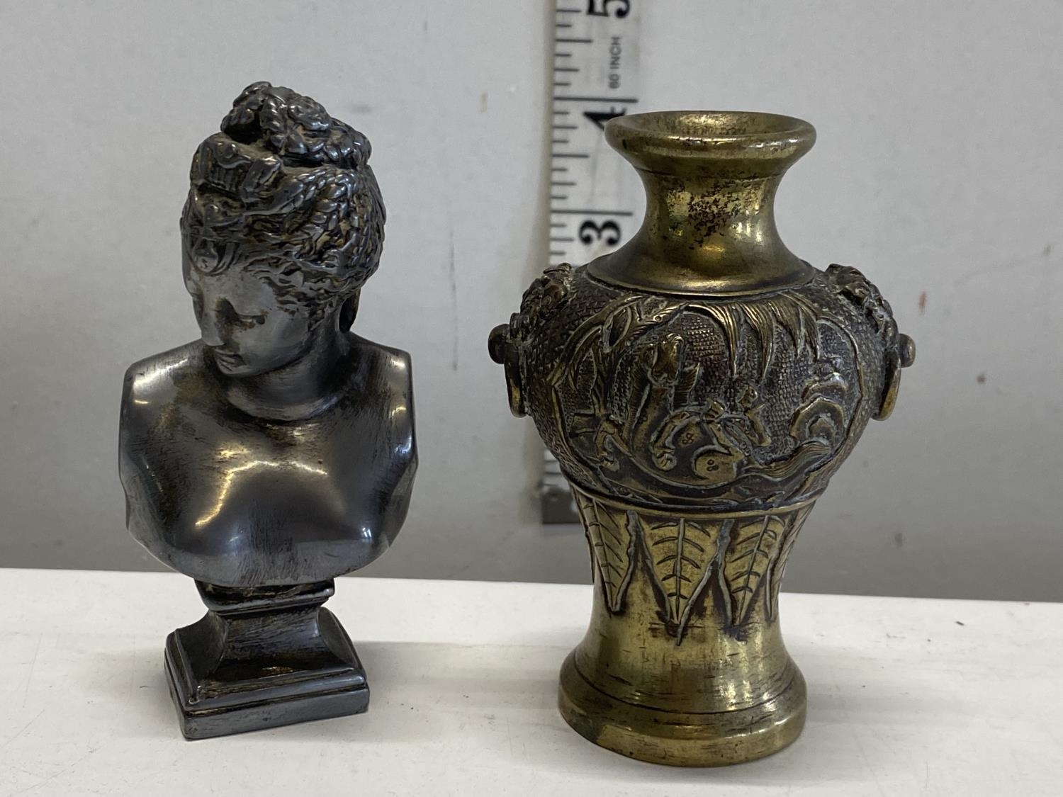 A small bronze urn and a small silvered bust of a lady
