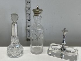 A silver collared scent bottle and two other dressing table items