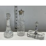 A silver collared scent bottle and two other dressing table items