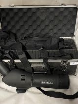 A cased Meade spotting scope with tripod