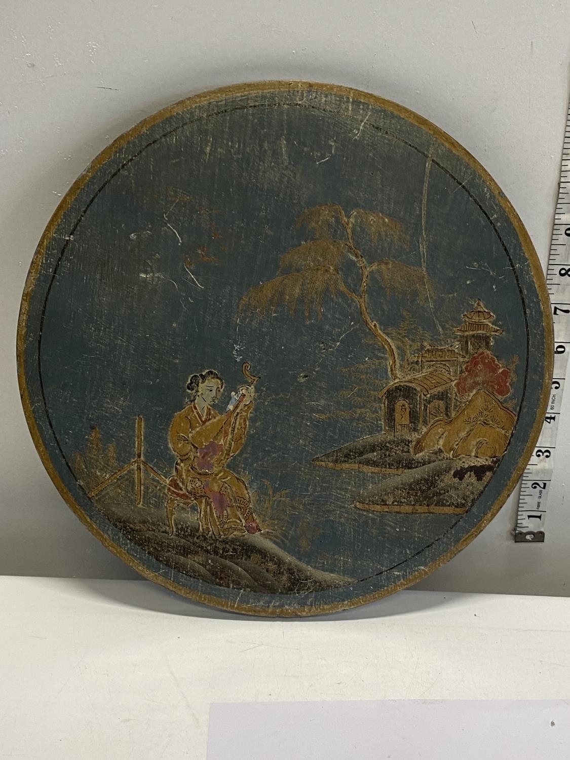 A Chinese circular gold gilt painting on wood