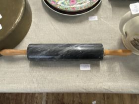 A vintage marble rolling pin with wooden handles