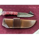 A hand forged Damascus steel bladed knife in leather sheath, over 18's only, UK post only