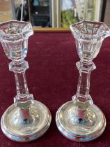 Two hallmarked silver based candlesticks with glass stems