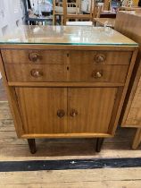 A vintage Gordon Russell cabinet with under cupboard and two graduated drawers with contents of