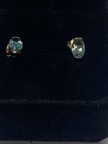 A pair of 9ct gold & blue topaz earrings.