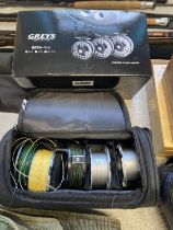 Two fly fishing reels and three spare spools