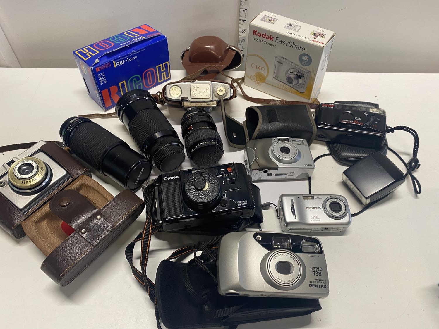 A job lot of assorted vintage cameras and 35mm lenses